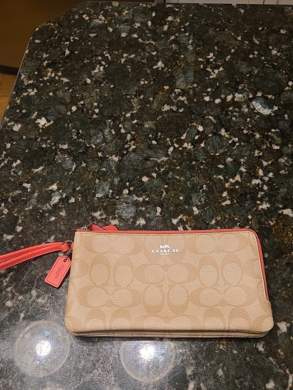 Coach Signature Canvas Wristlet in Khaki with Orange Trim.